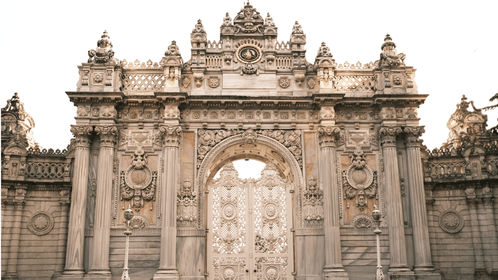 Ornate stone entrance gate with decorative carvings and intricate metalwork.